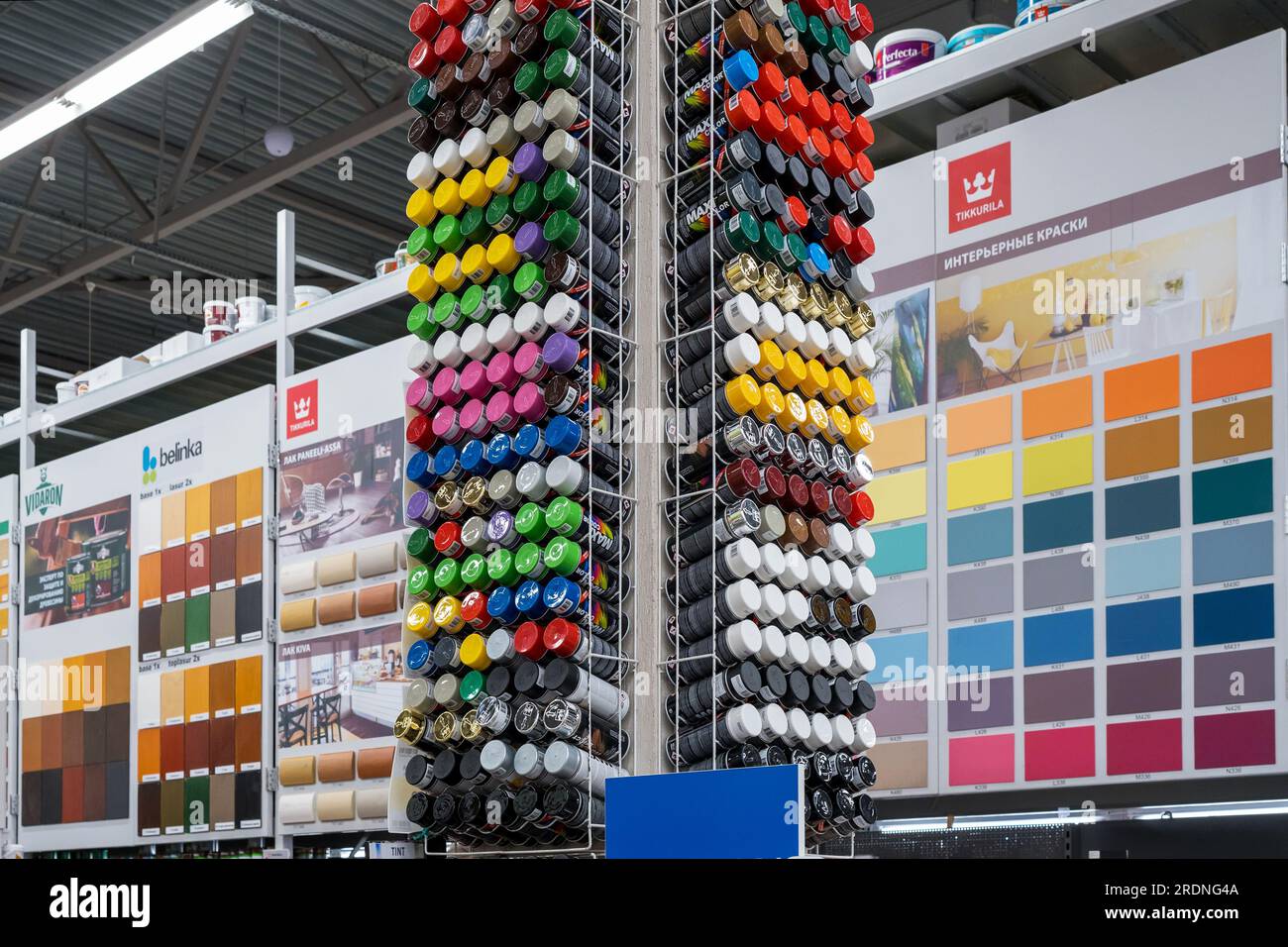 Paint store interior. Rack with multicolored spray paint containers
