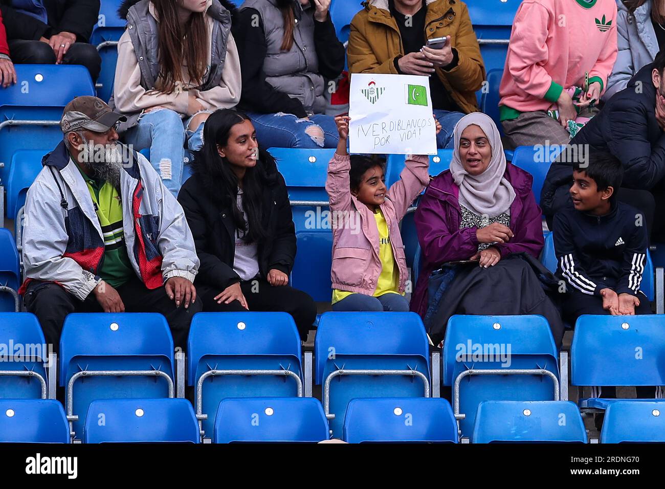 A young Real Betis fan holds up a sign with the Betis logo and the flag of Pakistan with ÒÁVerdiblancos Por Vida!Ó translating as ÒGreen and Whites For LifeÓ with Verdiblancos the nickname of Betis during the Pre-season friendly match Real Betis vs Middlesbrough at SMH Group Stadiumact Stadium, Chesterfield, United Kingdom, 22nd July 2023  (Photo by Ryan Crockett/News Images) Stock Photo