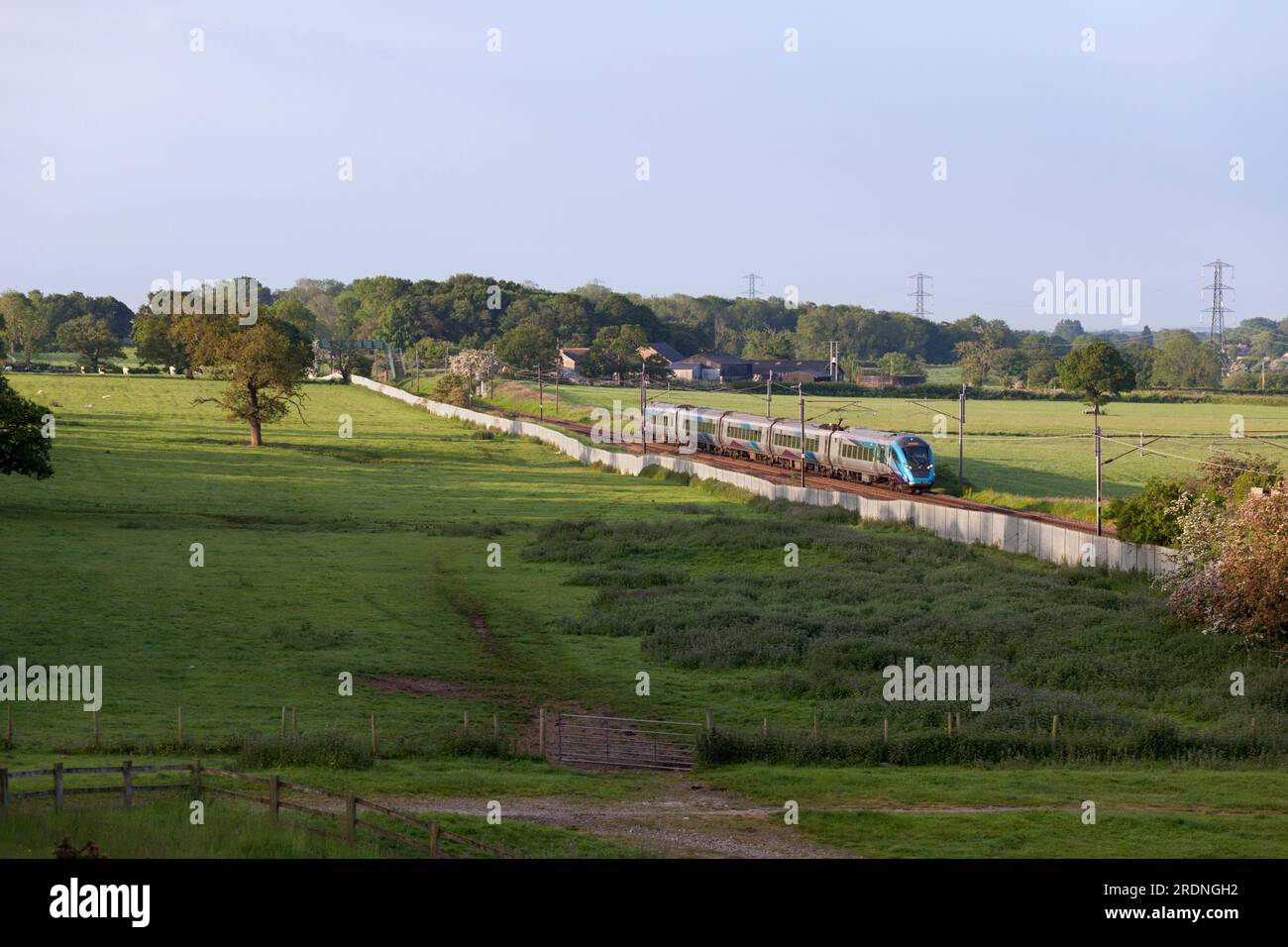 First Transpennine Express CAF class 397 electric train 397001 passing the countryside on the west coast mainline in Lancashire Stock Photo