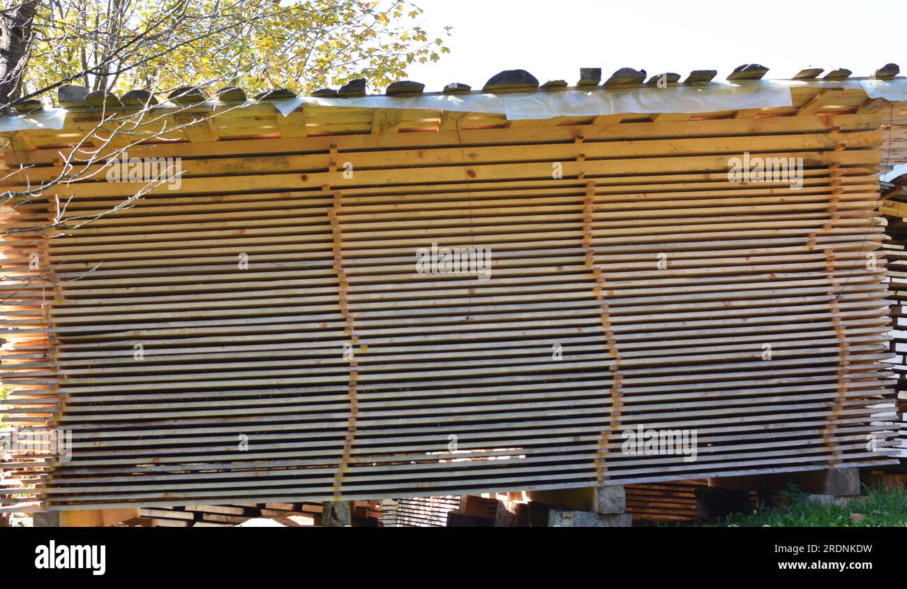 Raw wood under cover in the fresh air dries naturally Stock Photo Alamy