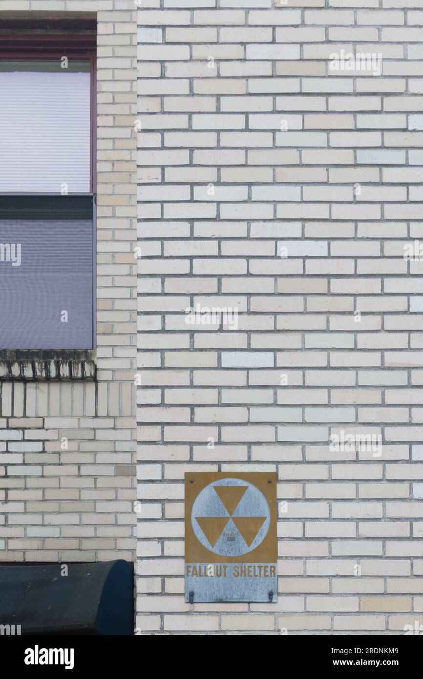 Brick wall with an old fallout shelter sign, Astoria, Oregon, USA. Stock Photo