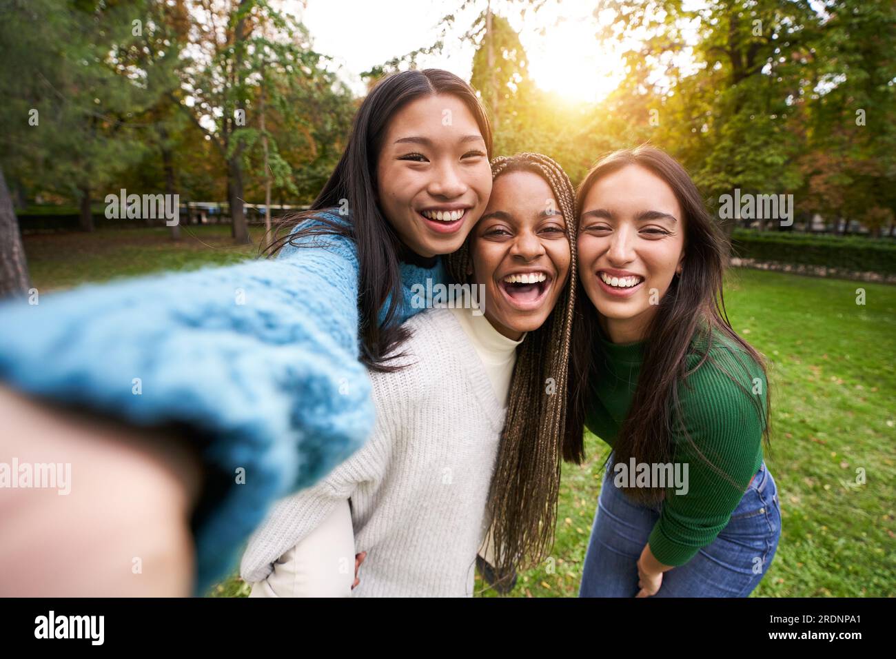 Portrait of three girls outdoor taking selfie. Friendship in multi-ethnic groups multiracial people Stock Photo