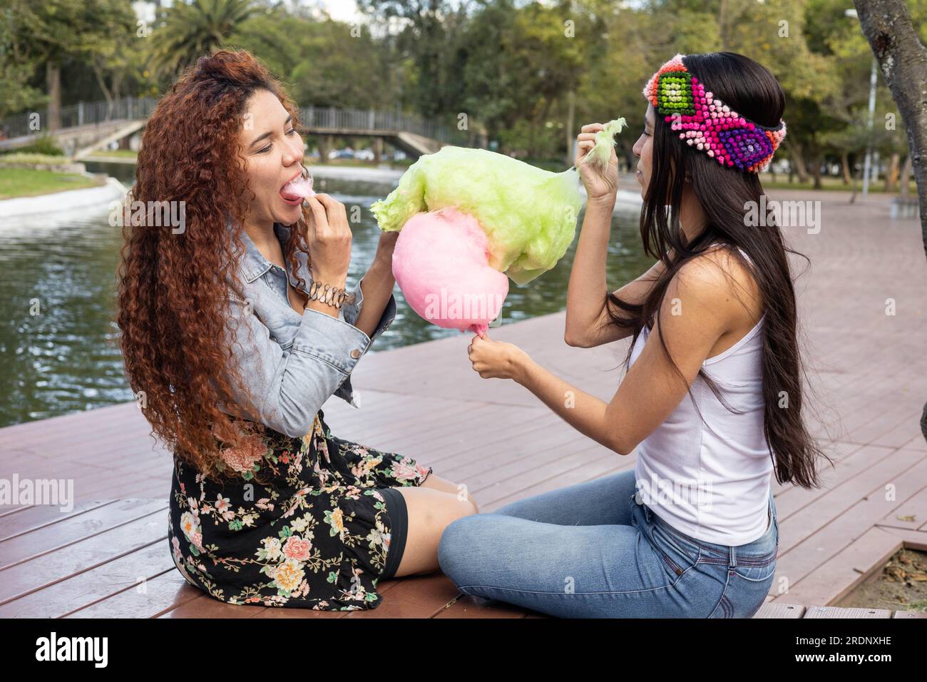 lifestyle of beautiful lesbian couple enjoying in a park, they share a  cotton candy and enjoy the day, romantic activities, latin young women  Stock Photo - Alamy