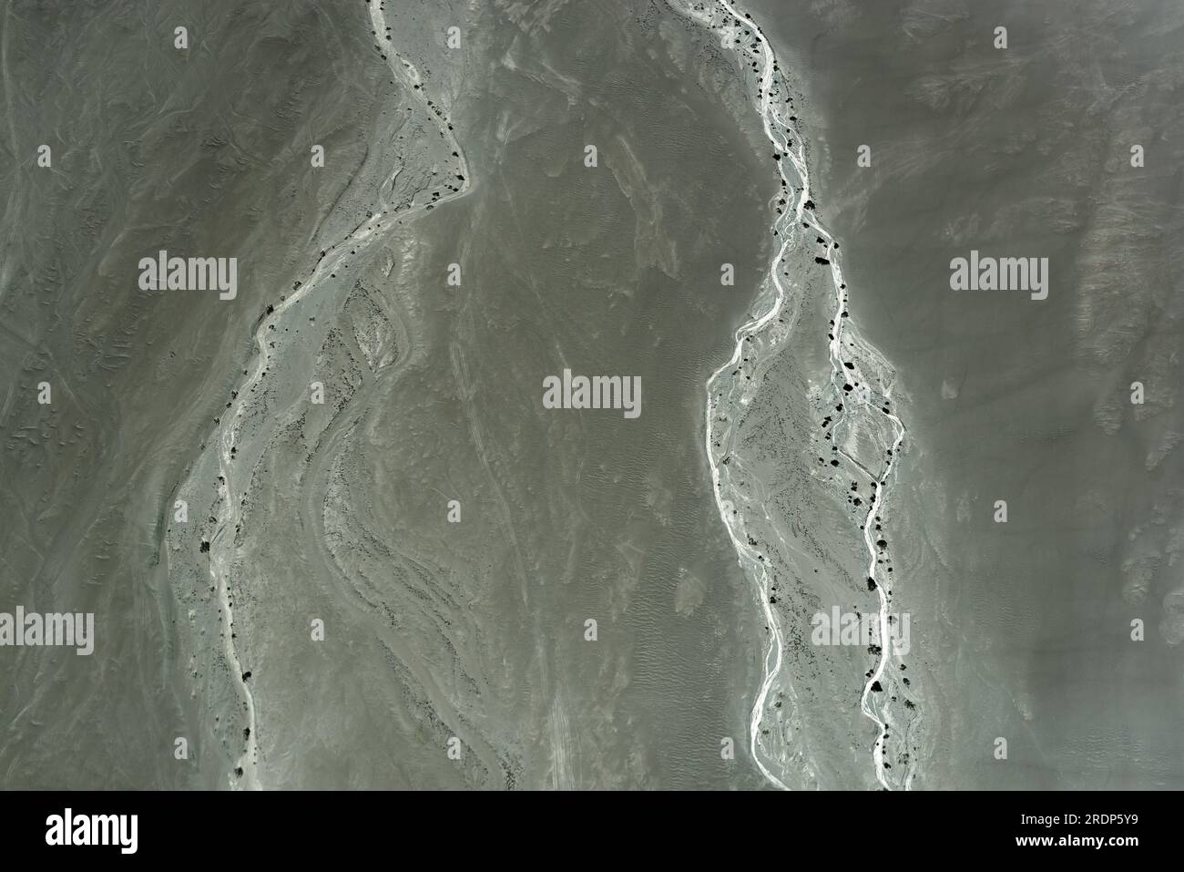 Aerial landscape view of the Nazca desert near Nazca Lines with dry riverbed and rivers during a flight, Peru. Stock Photo