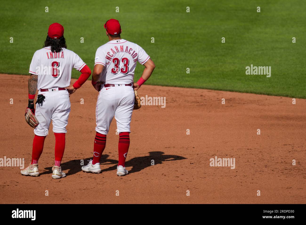 Cincinnati Reds' Jonathan India, left, receives the Major League Baseball  Rookie of the Year Award presented by Cincinnati Bengals' Ja'marr Chase  prior to a baseball between the Cleveland Guardians and the Cincinnati