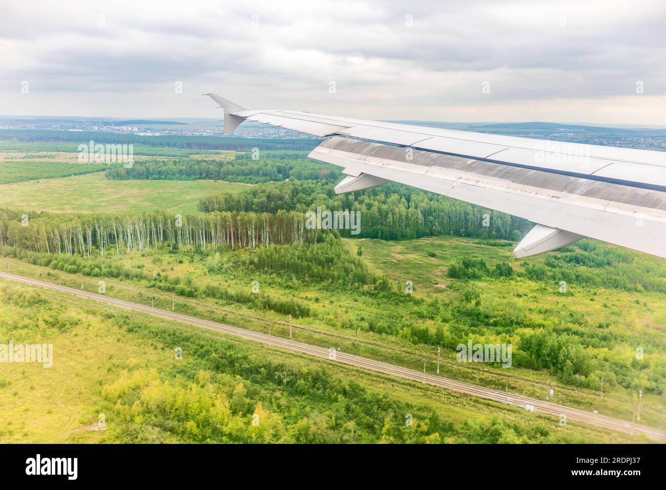view-of-airplane-wing-blue-skies-and-green-land-during-landing