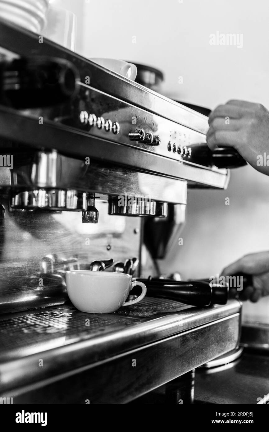 professional barista using classic espresso coffee making machine close