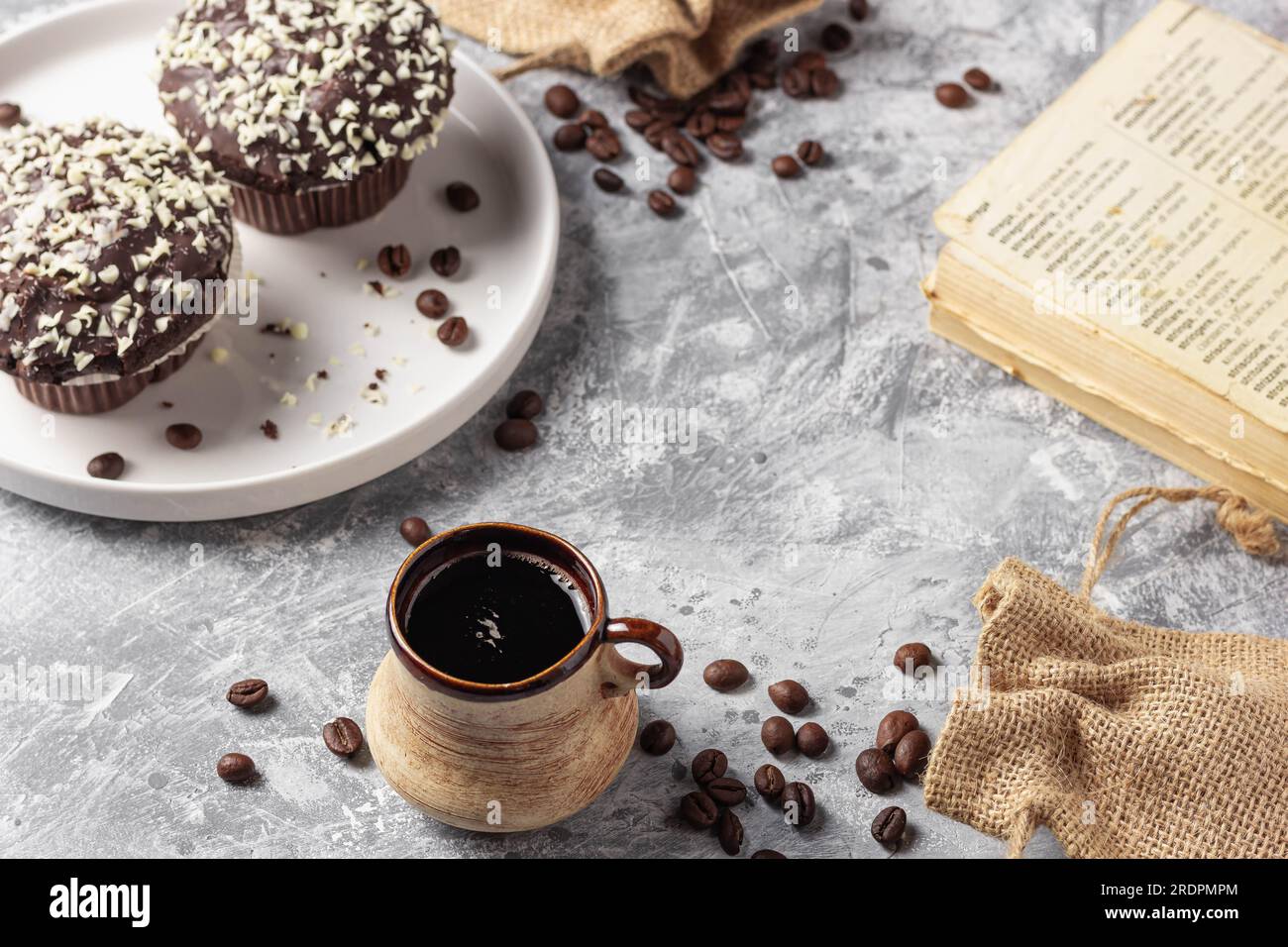 Roasted coffee beans in cup and cake on grey textured background Stock ...