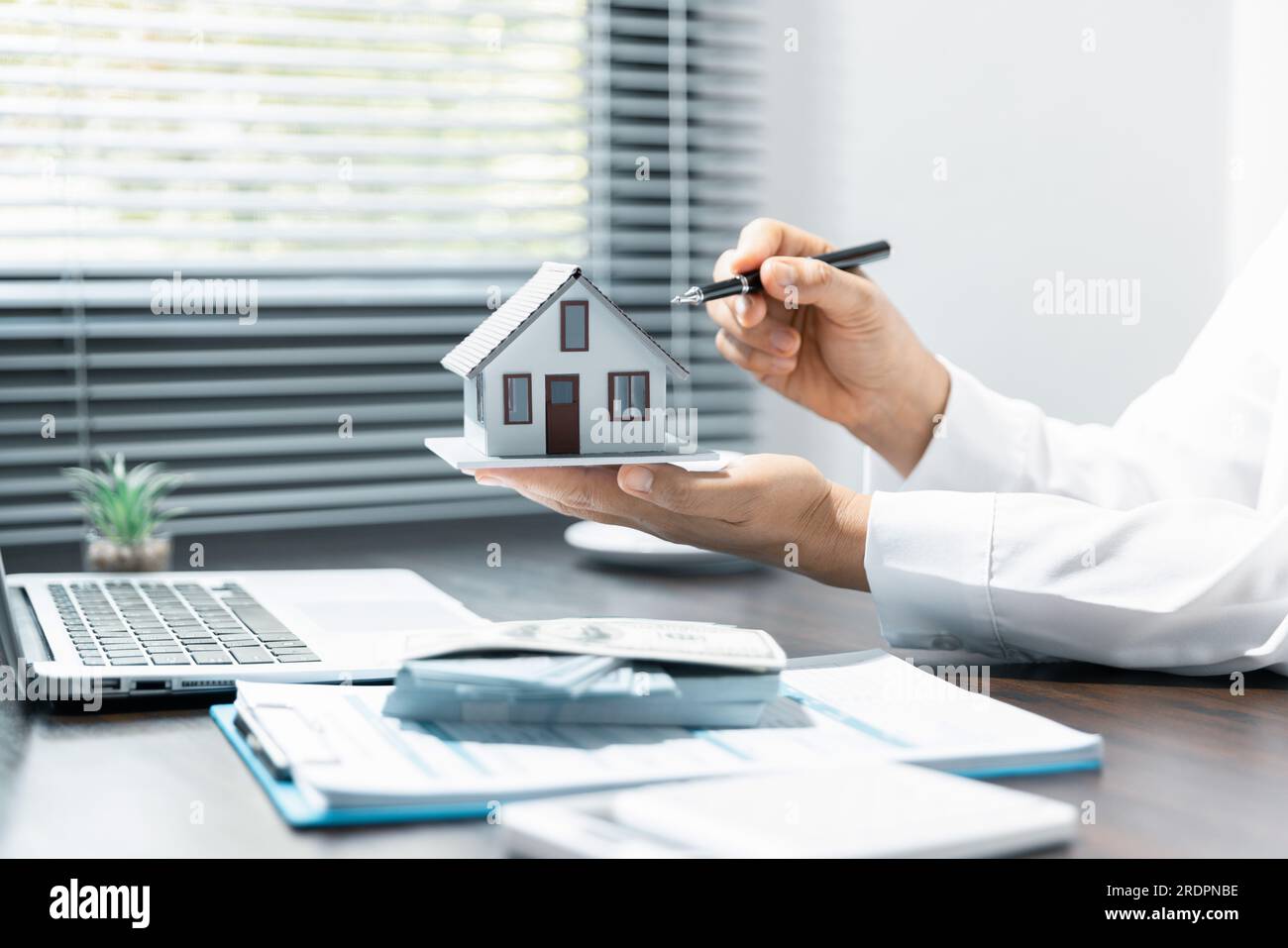 Single family house, concept of real estate, Sales manager or real estate agent prepares to hand over the keys and the house together with the insuran Stock Photo