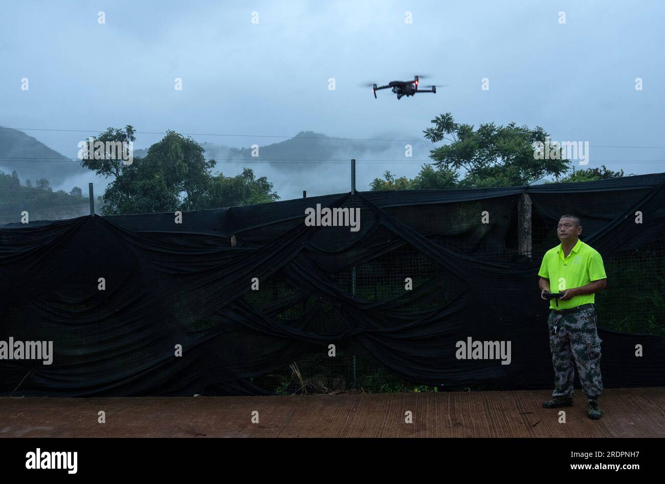 (230723) -- JIANGCHENG, July 23, 2023 (Xinhua) -- Diao Faxing, member of an elephant monitoring squad, launches a drone to track the movement of wild Asian elephants in Jiangcheng County, southwest China's Yunnan Province on July 20, 2023 Thanks to uncompromising environmental and wildlife protection efforts, the population of wild Asian elephants in Yunnan has been growing in recent years. Feeling much safer than before, some of these elephants have become increasingly 'rampant,' and a daring 'group tour' of an elephant family in the province even made a great scene in the global cyberspace b Stock Photo