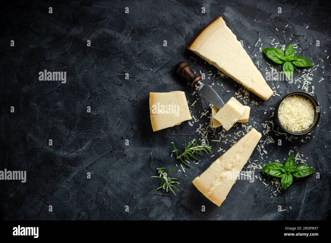 Parmesan cheese. Hard cheese on a dark background. banner, menu, recipe