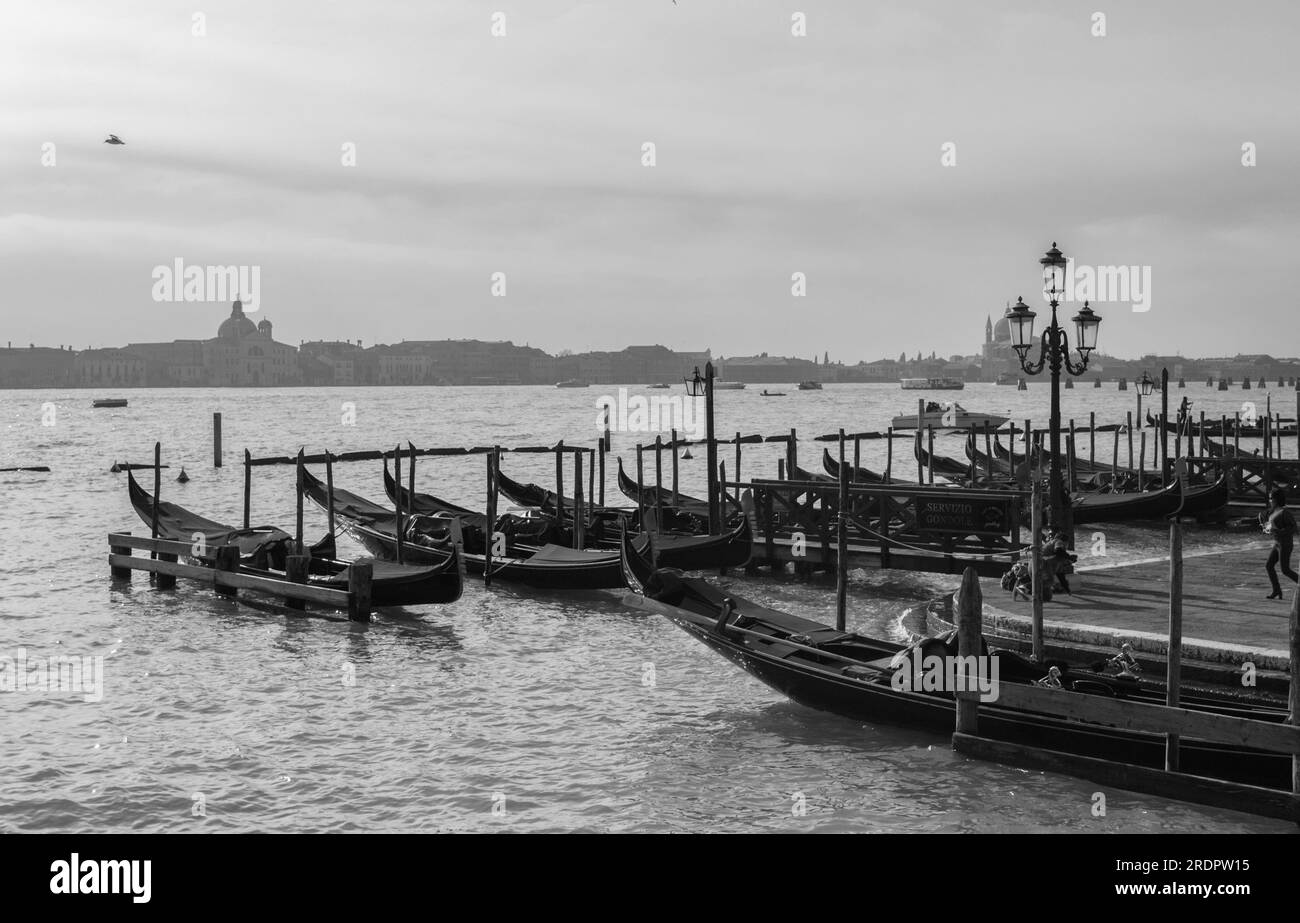 Early morning view of Venice waterfront with gondolas waiting to be hired for tourist rides at