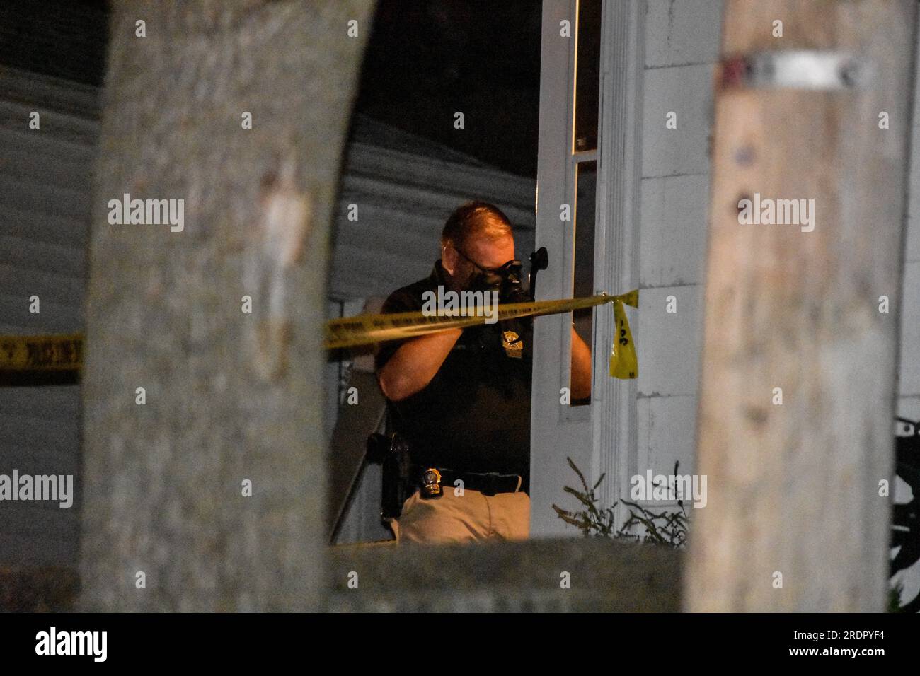 Crime scene investigator gathers evidence at the crime scene. A person