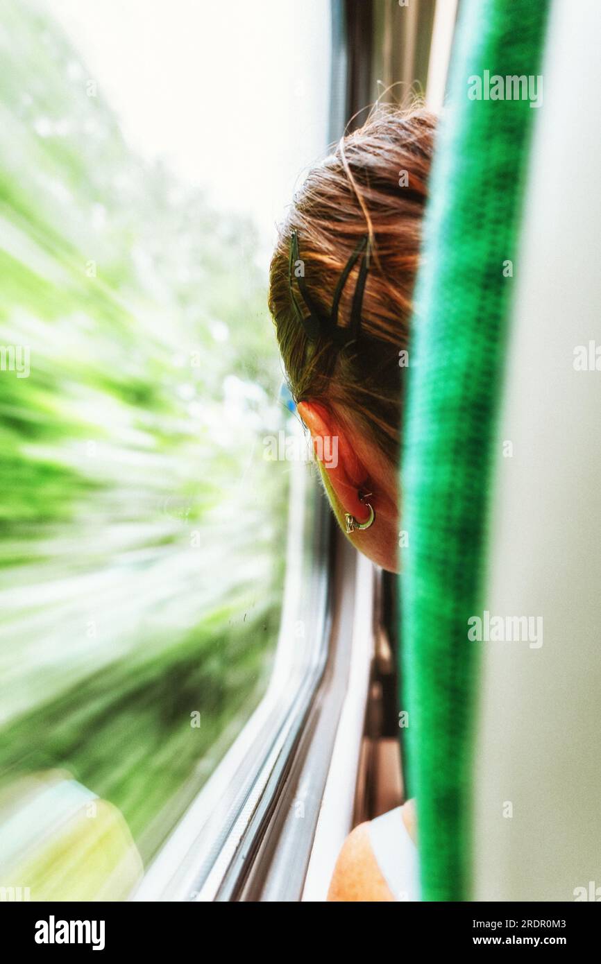 Rear view of the woman travelling on a train Stock Photo - Alamy