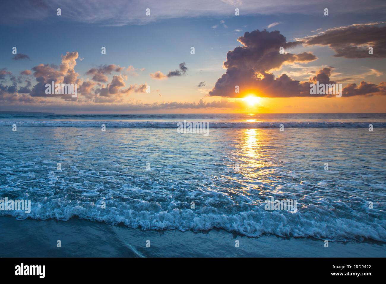 Splashing ocean wave in front of beautiful sunset sky background Stock ...