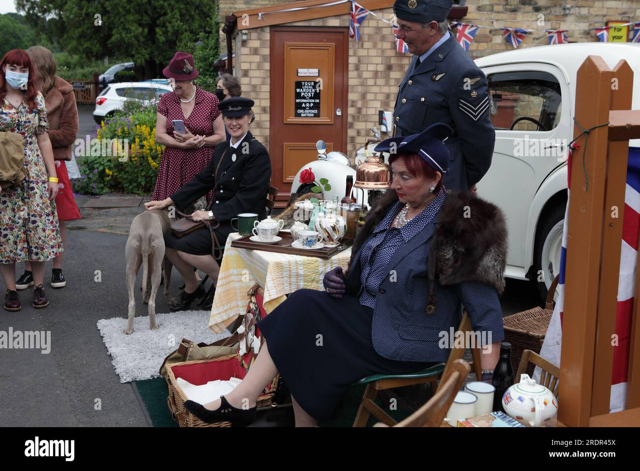 Revellers all dressed up to the nines enjoy a short break at Arley Station in Shropshire during the Severn Valley Railway 1940s day. Stock Photo