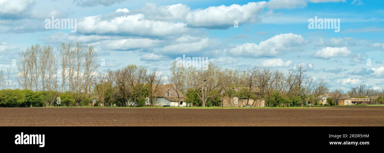 Typical old salas in Vojvodina, a traditional type of property in the Pannonian Plain region, with family house and agricultural objects, surrounded b Stock Photo