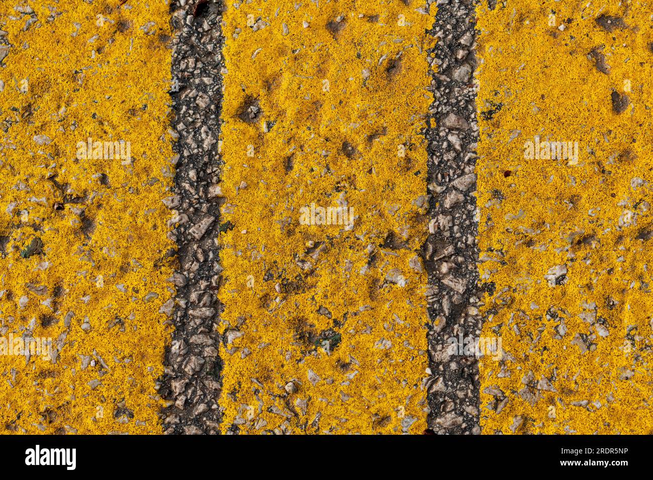 Yellow strip pattern on asphalt road as abstract background, top view Stock Photo