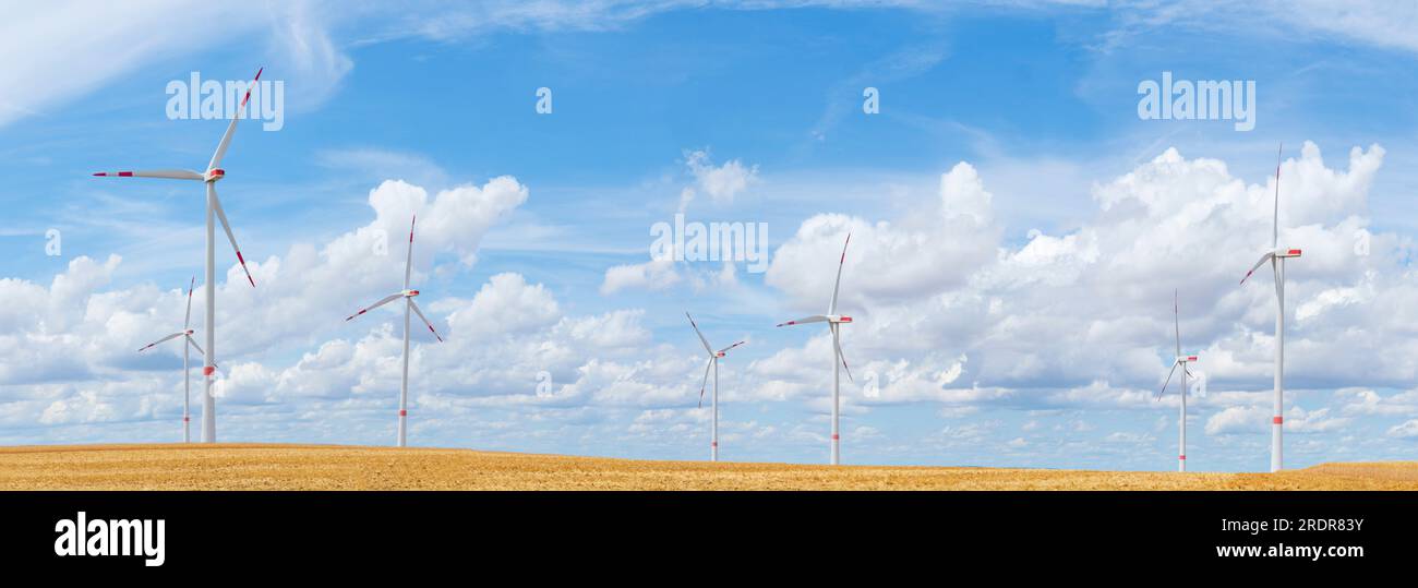 Large panorama of wind turbines with blue sky and white clouds in the ...