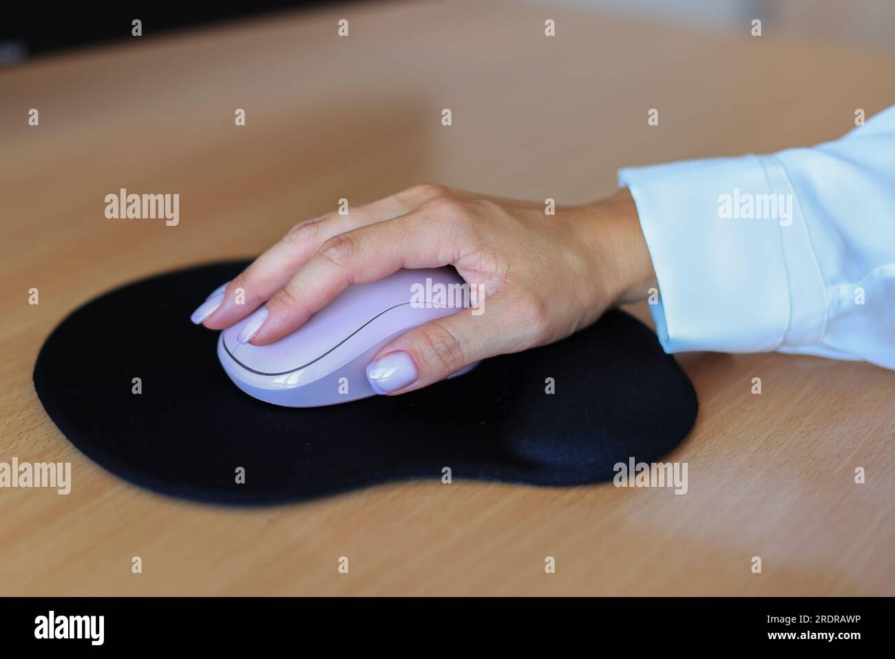 Female hand with computer mouse on table, closeup Stock Photo