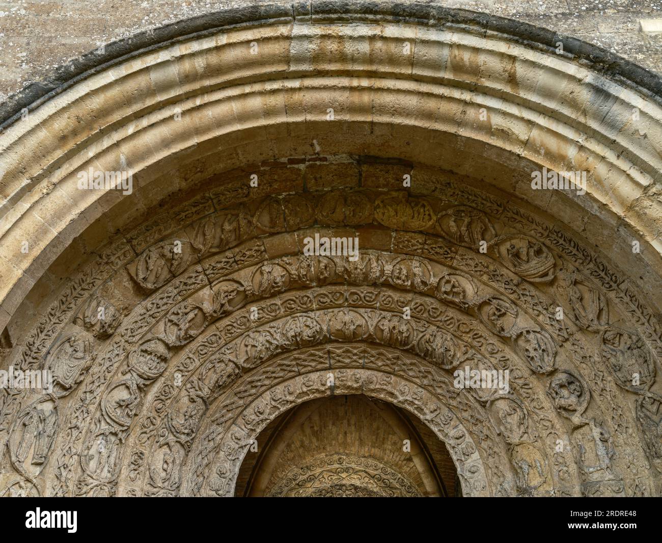 A high resolution image of Malmesbury Abbey Porch showing the weathered carvings that adorn the entrance to the ancient Benedictine Monastery. Stock Photo