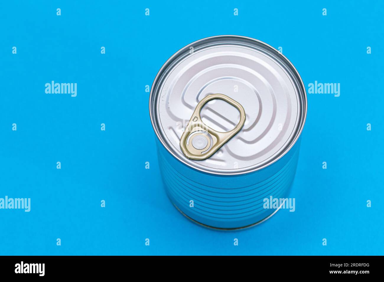 Unopened Tin Can with Blank Edge on Light Blue Background. Canned Food
