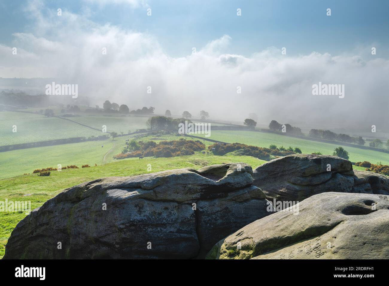 Mist around Almscliffe Crag and the Lower Wharfe Valley in late May. Stock Photo