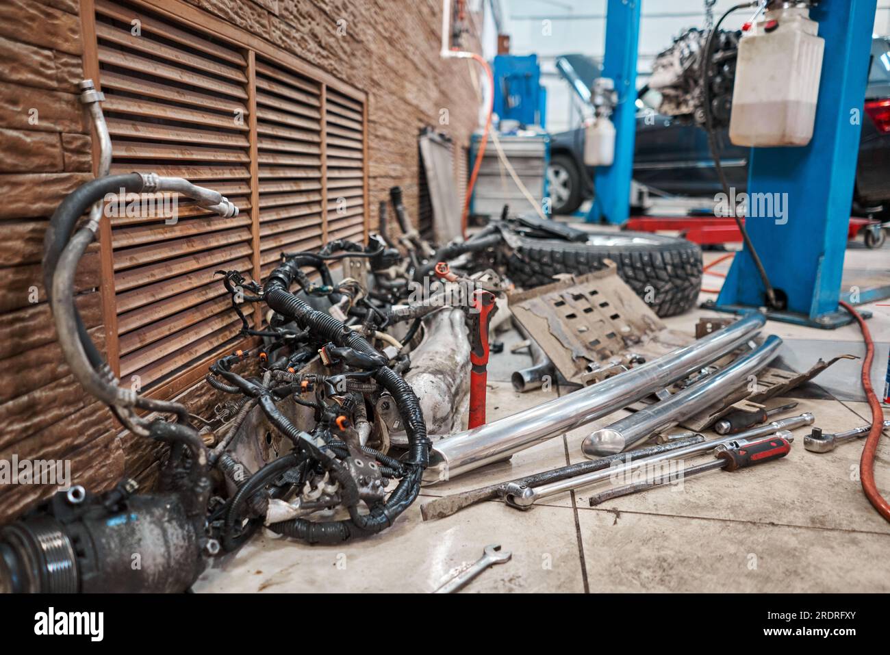 Lot of old car spare parts in service garage. Repair and recovery of
