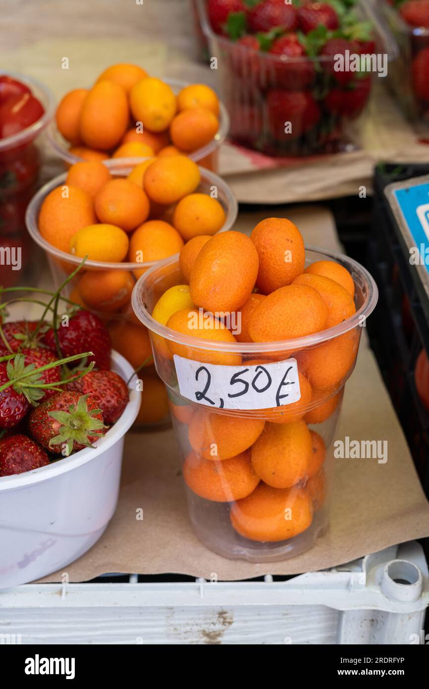 Fresh orange kumquat fruit sold in a cup at a local market in Greece Stock Photo