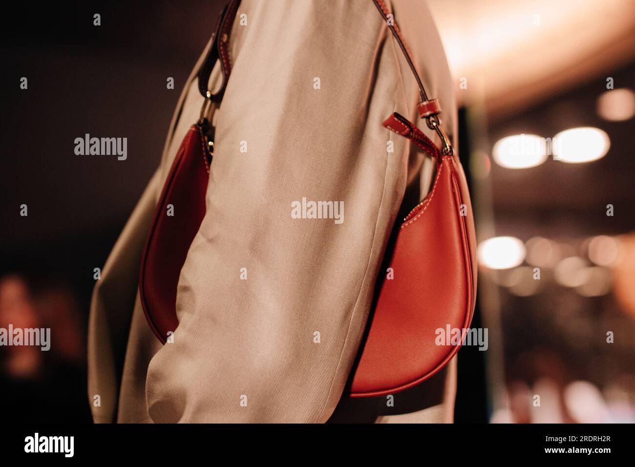 Fashion details of beige classy jacket and brown leather small handbag. Warm natural tones. Fashion cloth concept Stock Photo
