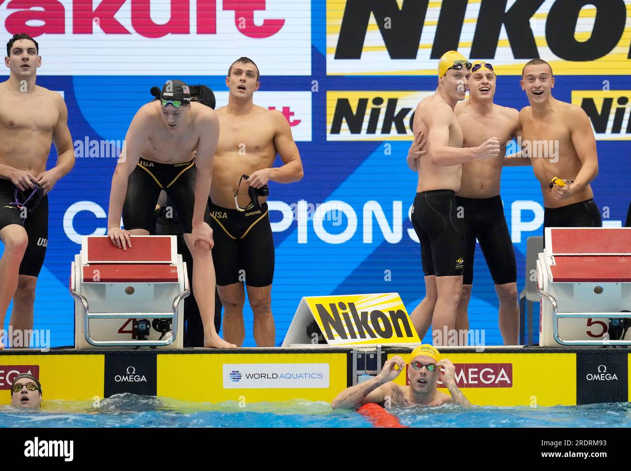 Australian swimmers, right, celebrate as their team about to win Men 4