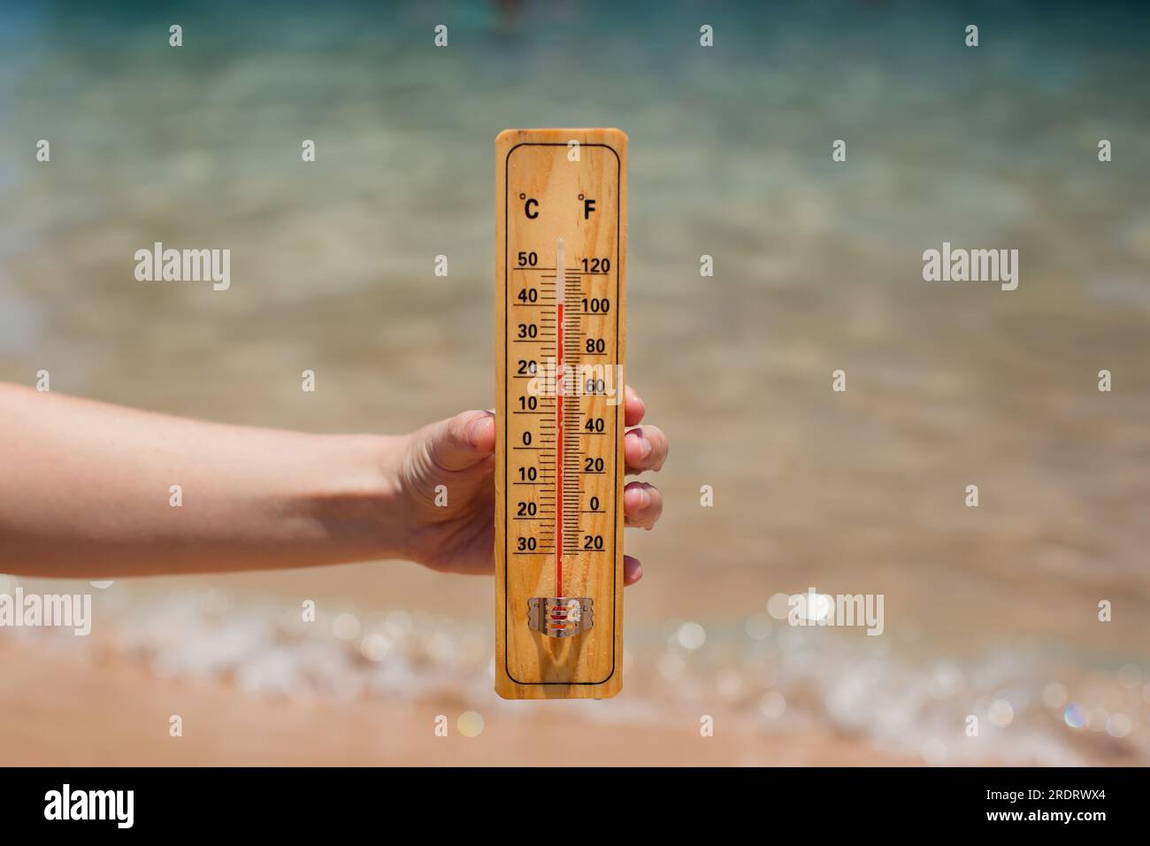 Thermometer measures the temperature of the water Stock Photo - Alamy