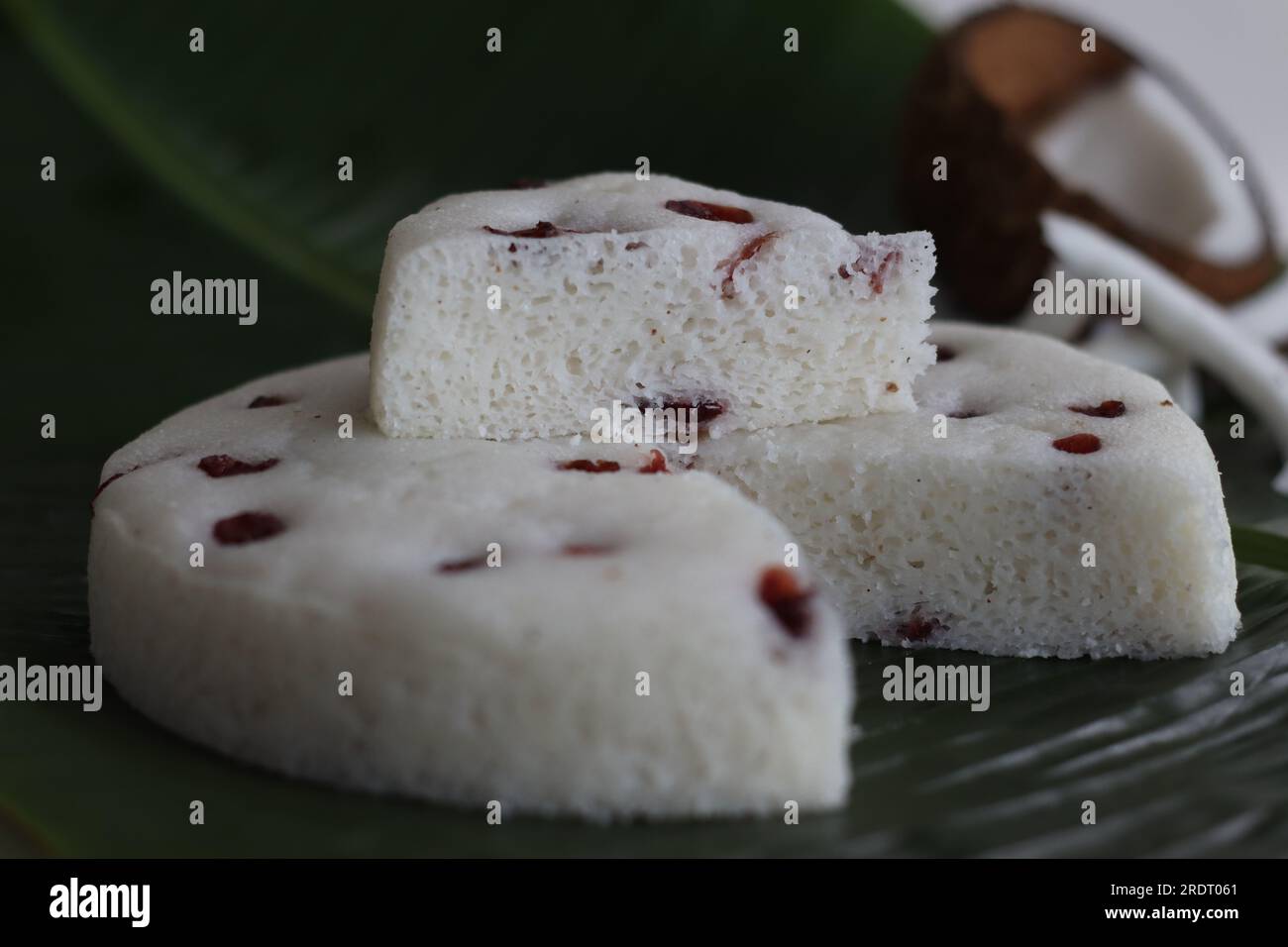 Vattayappam slices. Steamed spongy rice cake topped with dried cranberries. A traditional tea time snack from Kerala, prepared with a fermented batter Stock Photo