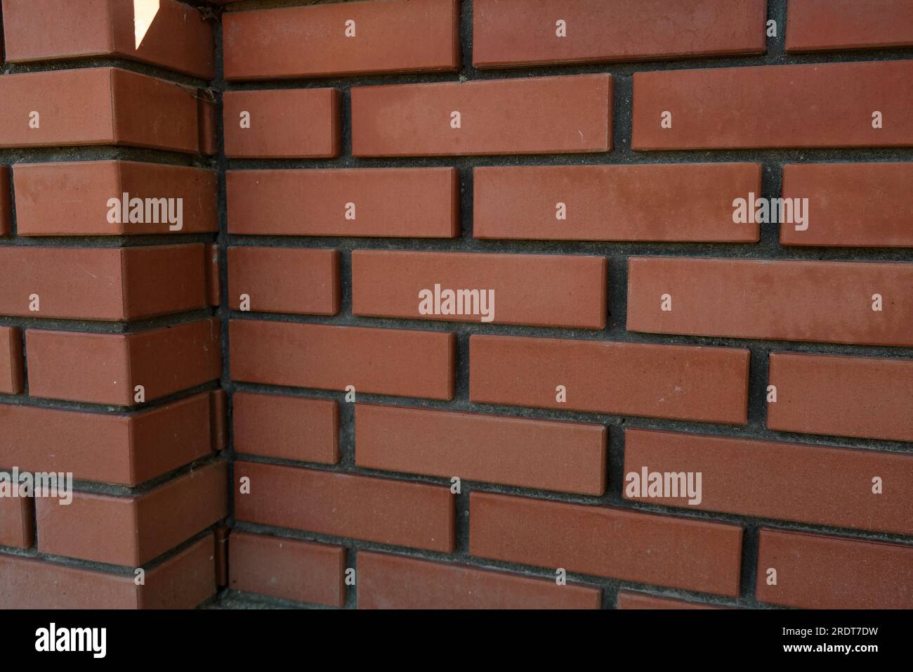 Red brick and brick edge from pillar in front of wall as texture background Stock Photo