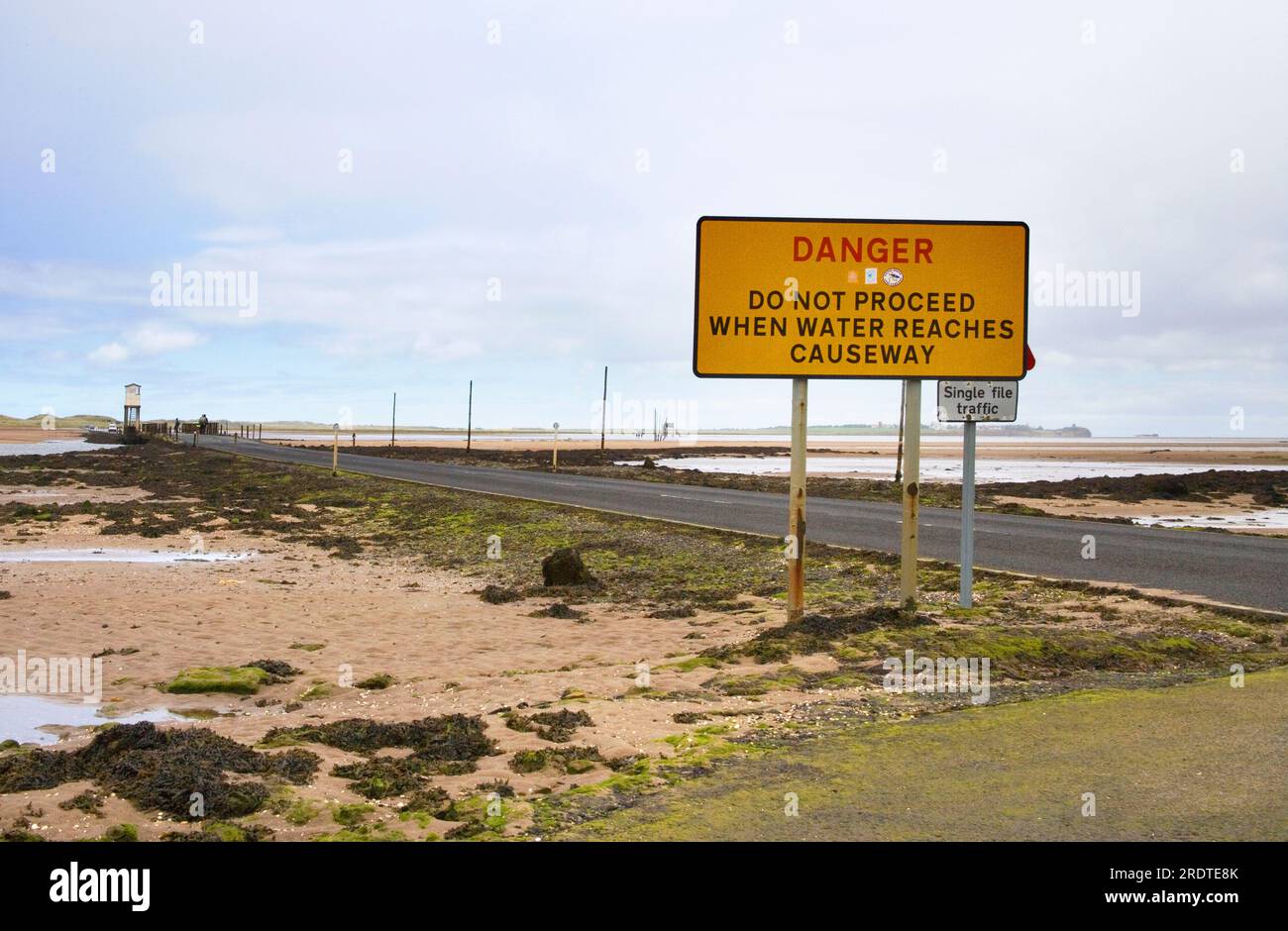warning signs on the causeway at holy island off the northumberland coast Stock Photo