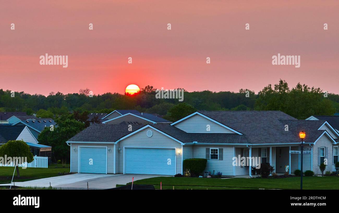 Sun Rising Setting Sun rising setting over forest tree skyline suburban neighborhood home ...