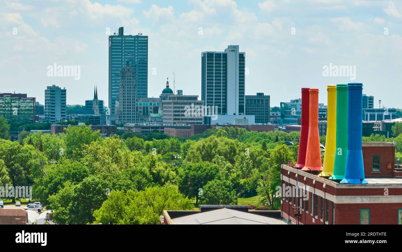 Science Central rainbow smokestacks with distant downtown Fort Wayne
