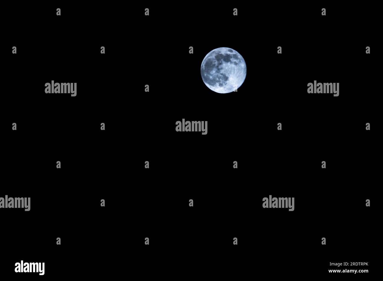Full moon in front of clear dark sky over hamburg, germany, 2023,  horizontal format Stock Photo