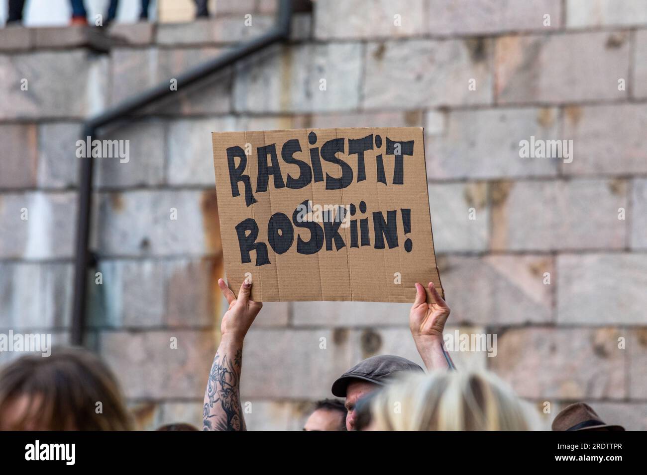 Rasistit roskiin! Cardboard sign at Nollatoleranssi! Zero Tolerance! demonstration against far-right politics in Petteri Orpo's coalition government. Stock Photo