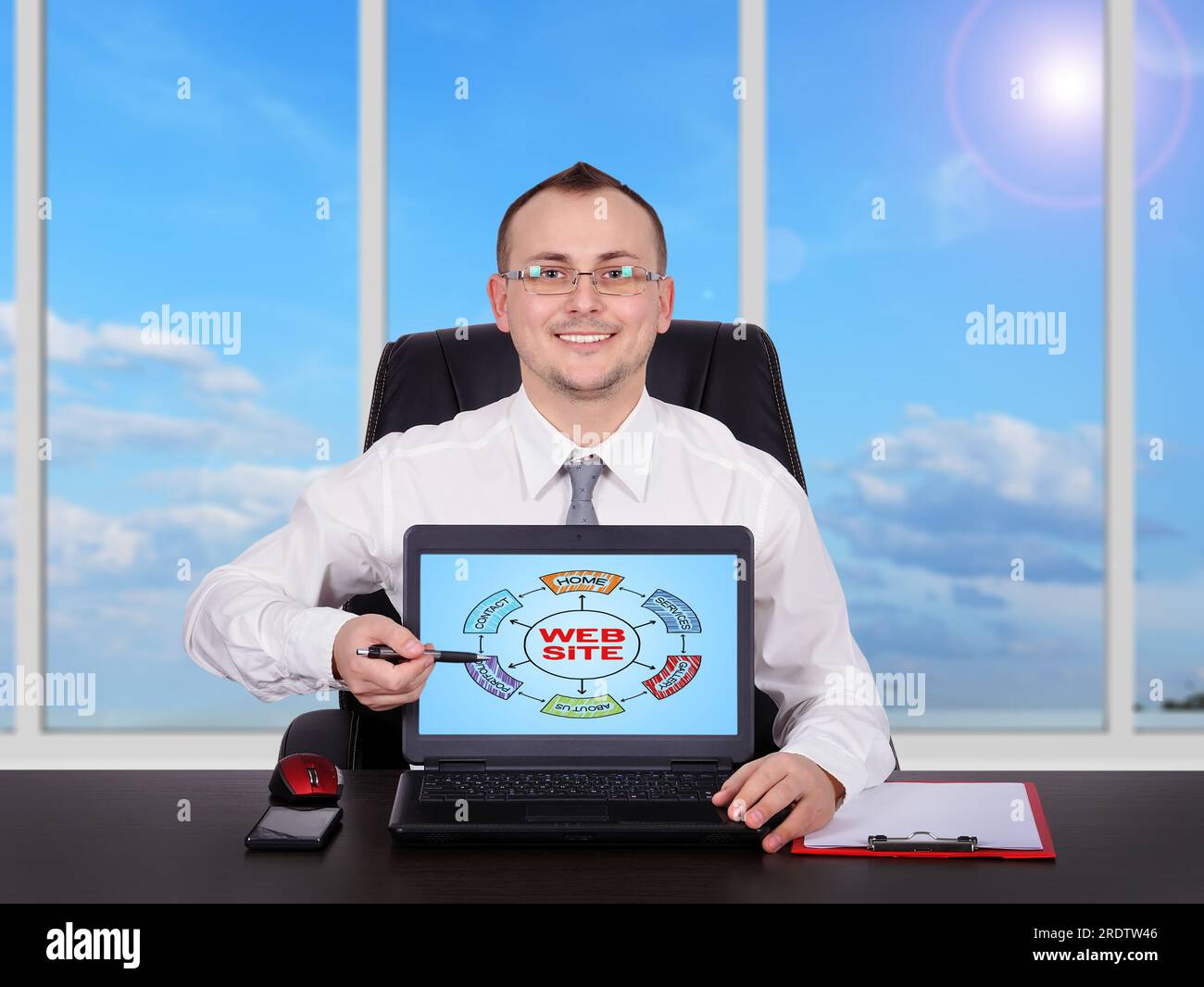 businessman sitting in office and pointing to screen laptop with scheme website Stock Photo
