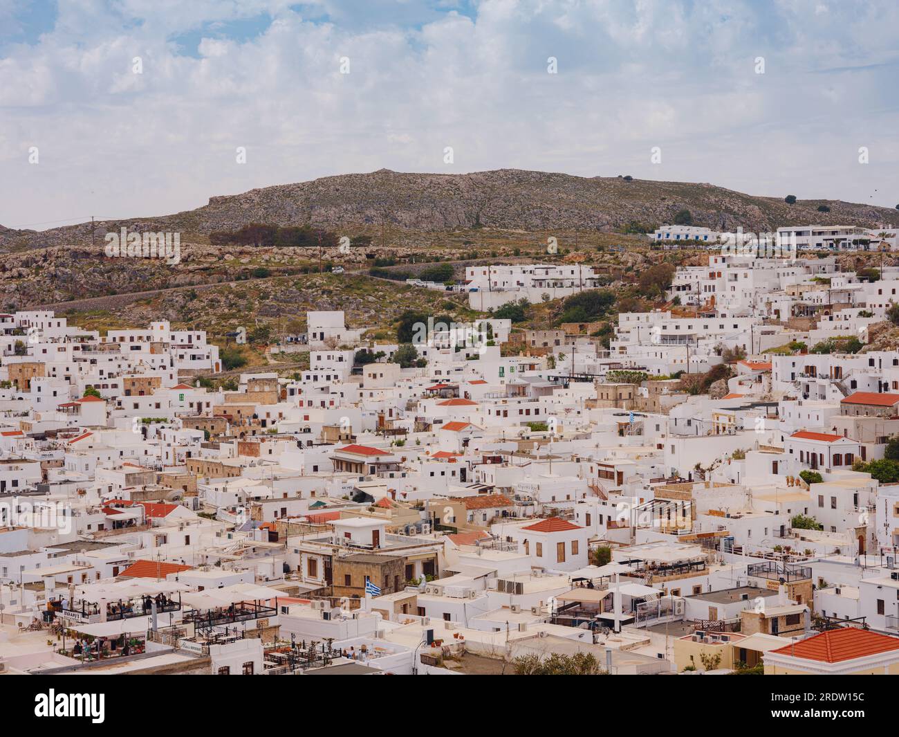 Lindos town in Greece aerial view in cloud summer day, white houses in Rhodes island , cityscape viewpoint traditional greek architecture, famous land Stock Photo