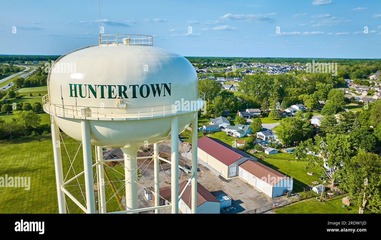 Close up aerial of Huntertown water tower with distant buildings and