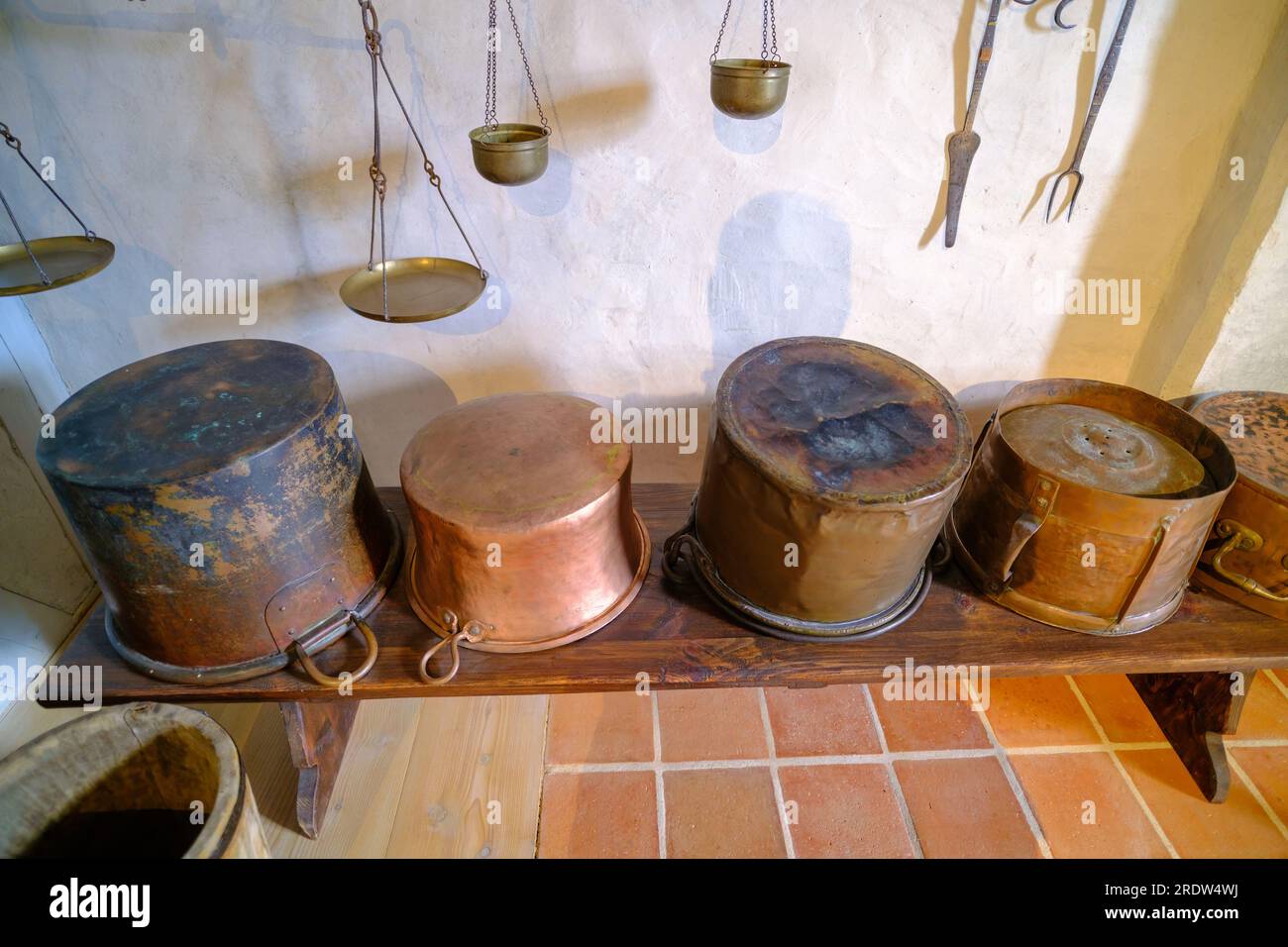 Ancient brass pots. Medieval kitchen metal cooking utensils. Interior