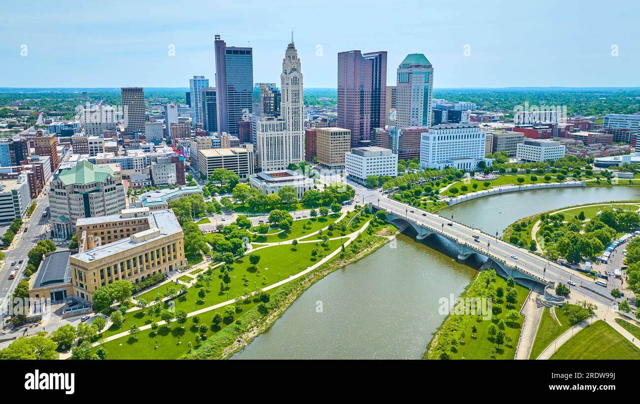 Drone view downtown Columbus Ohio over Scioto River with bridge and distant skyscrapers Stock Photo