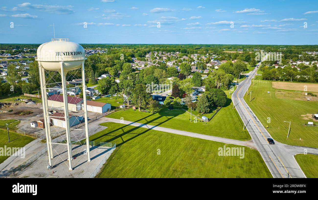 Aerial white water tower in Huntertown with distant neighborhoods Stock