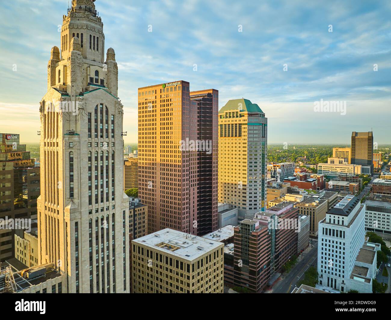 Golden lighting striking Huntington and LeVeque Towers at sunrise in