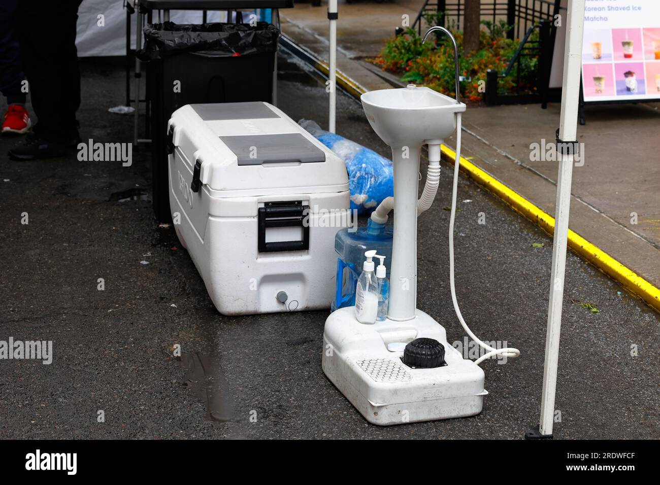 A portable handwashing sink, hand washing station at a street fair food vendor booth. Stock Photo