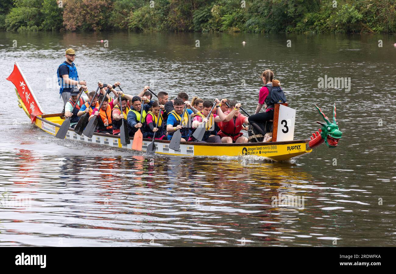 River Mersey, Warrington, Cheshire, UK. 23rd July, 2023. An organised Dragon Boat Festival along the River Mersey in Warrington. Held at the Rowing Club and despite the continuous rain throughout the day, a number of Dragon Boats competed to find an eventual winner. The event was to raise funds for St Rocco's Hospice who's aim is to provide quality care and support for those people and their loved ones with life limiting disease who live in the Warrington area to enable each person to find comfort, hope, strength and peace. Credit: John Hopkins/Alamy Live News Stock Photo