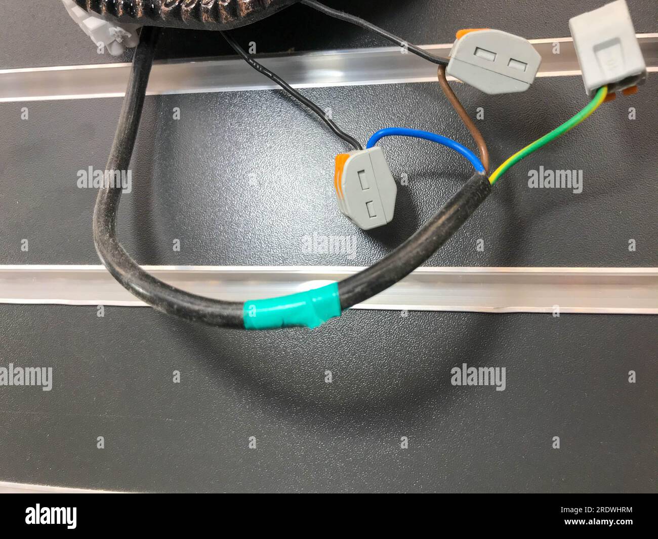 electrical wires in the lamp. wires wrapped with electrical tape at the