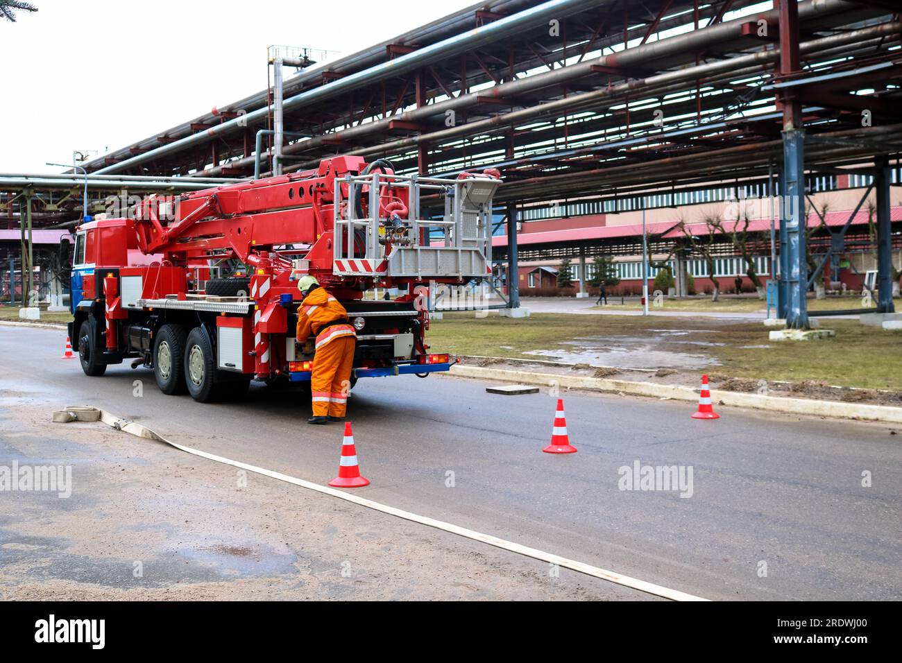 Firemen rescue workers in fireproof suits came to extinguish a fire in